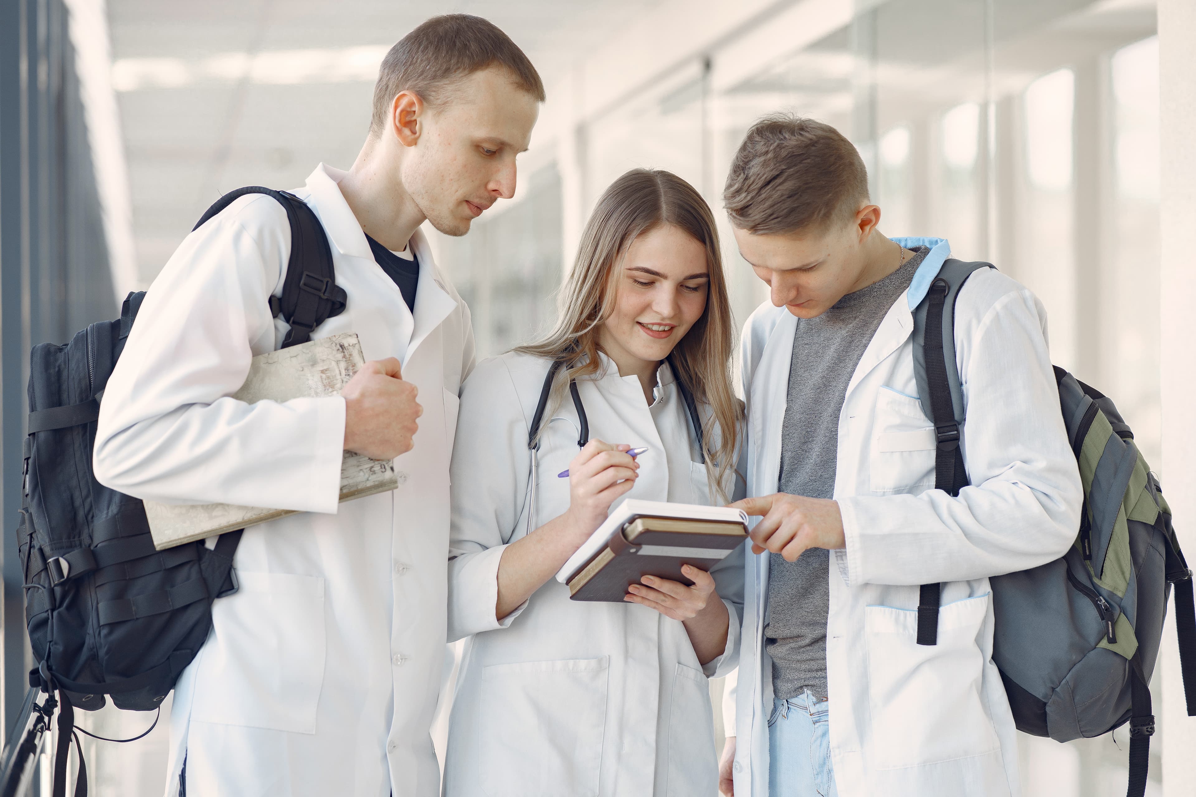 Medical students reviewing notes together in a hallway